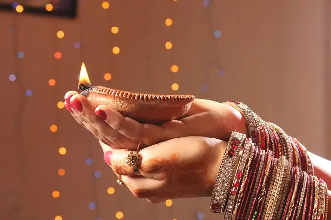 Lady holding candle for Diwali
